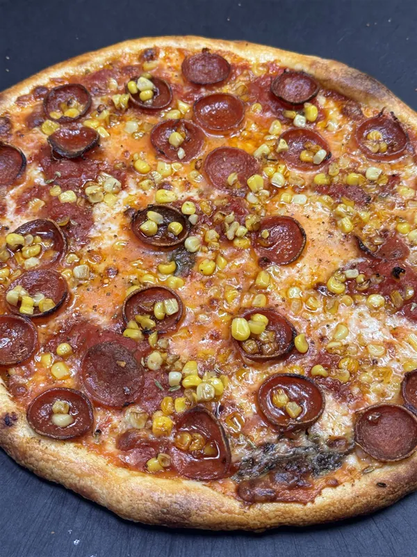 Whole pepperoni and street corn pizza with cupped pepperoni
