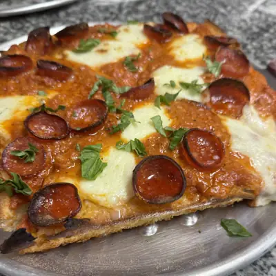 Two Sicilian slices with vodka sauce, mozzarella and pepperoni